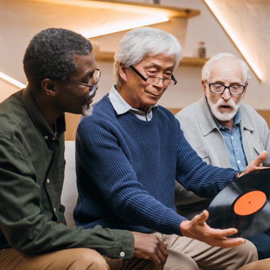 group-of-senior-friends-with-vinyl-record-sitting-2024-11-19-09-16-53-utc